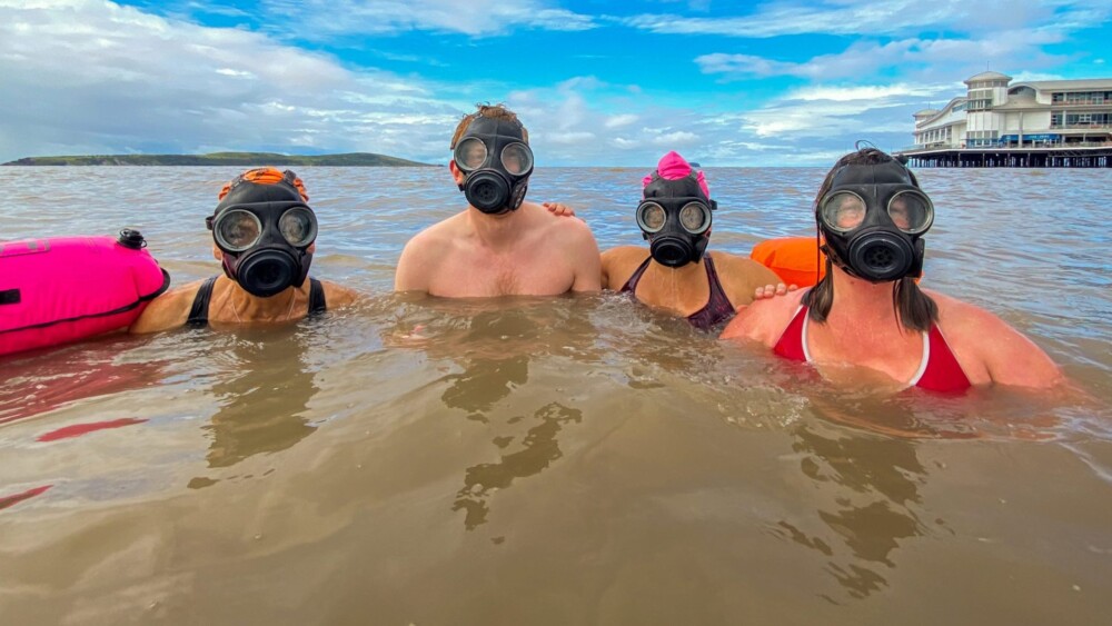 Swimmers wearing gas masks